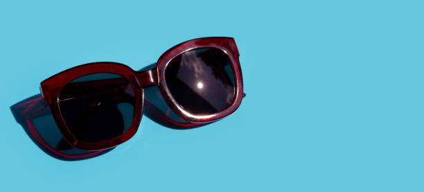 istock Sunglasses on blue background. Enjoy holiday concept. 1298436106