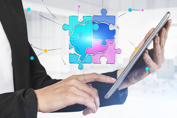 istock Woman with tablet in office and puzzle sketch 1298437568