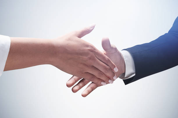 istock Man and woman shaking hands 1298437655