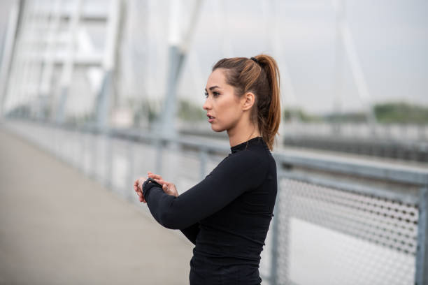 istock Young lady is set the time. 1298439477