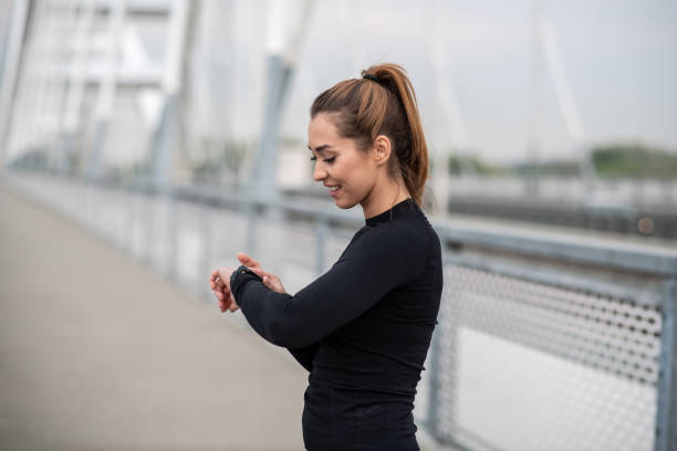 istock Young woman looking at wrist watch. 1298439532