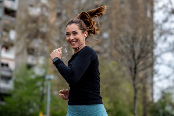 istock Young woman jogging around the block. 1298439602