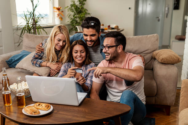 istock Friends cheering for their team and betting online 1298440149