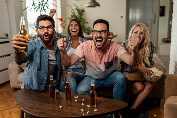 istock Friends watching sport on tv 1298440222