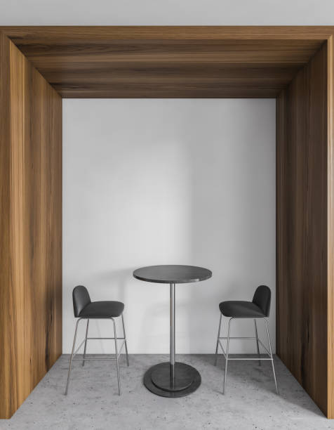 istock Two black bar chairs with table with hard wooden partition and marble floor 1298441098