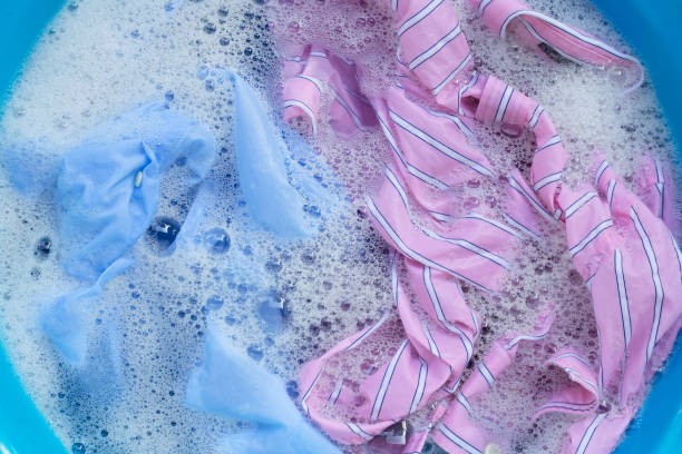 istock Color clothes soak in powder detergent water dissolution. Laundry concept 1298442797
