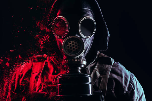 istock Stalker soldier face in soviet old gas mask with filter and red highlights dissolving. 1298445135