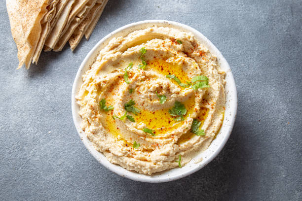 hummus cremoso fatto in casa sano con olio d'oliva e patatine pita - hummus foto e immagini stock