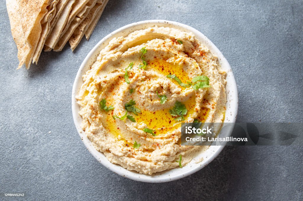 Healthy Homemade Creamy Hummus with Olive Oil and Pita Chips Hummus - Food Stock Photo