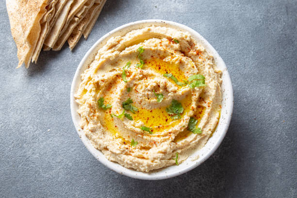 Healthy Homemade Creamy Hummus with Olive Oil and Pita Chips stock photo