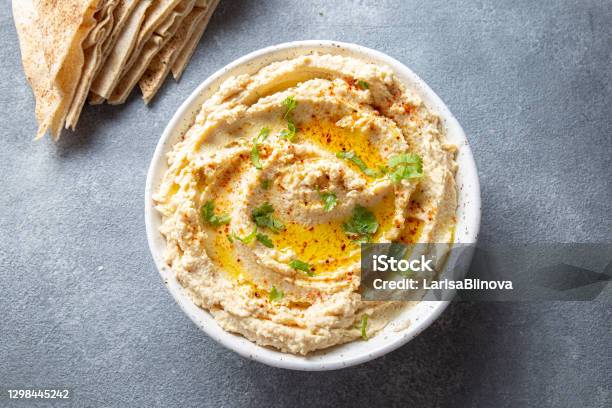 Healthy Homemade Creamy Hummus With Olive Oil And Pita Chips Stock Photo - Download Image Now