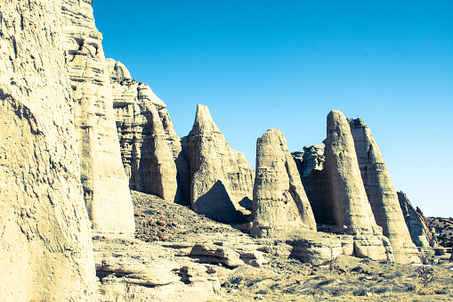 Abiquiu, NM:  Cliffs and rock hoodoos at the White Place/Plaza Blanca under a blue sky. White Place was a favorite painting locale for Georgia O’Keeffe. Abiquiu is about 40 miles from Santa Fe.