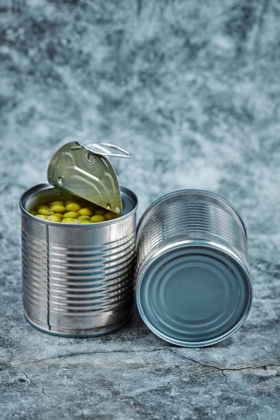 istock Two cans of boiled green peas on a marble background 1298447166