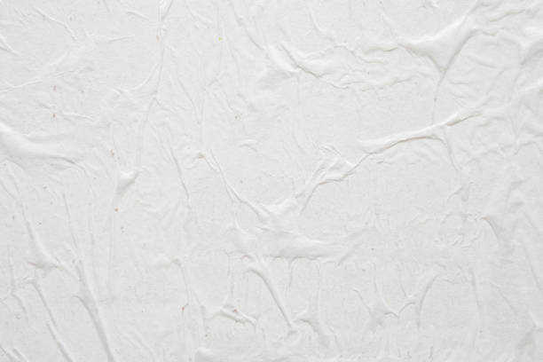 istock Blank white crumpled and creased paper poster texture background 1298447284