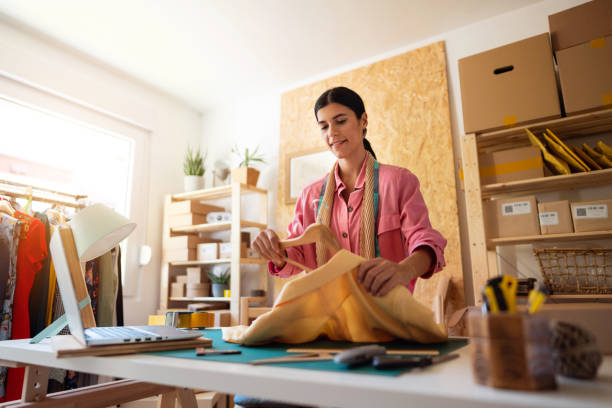 istock Female entrepreneur packaging goods for shipping 1298447468