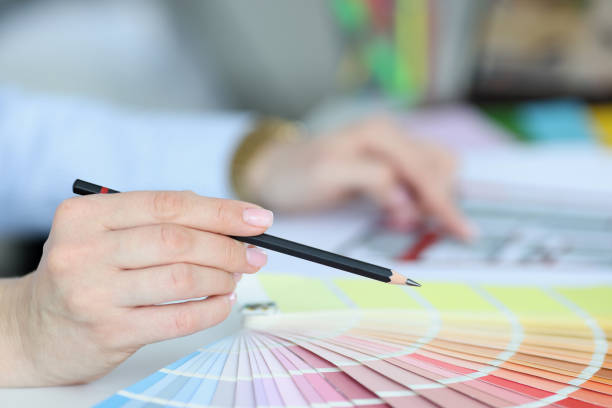 istock Black pencil in hand over color palette 1298461639