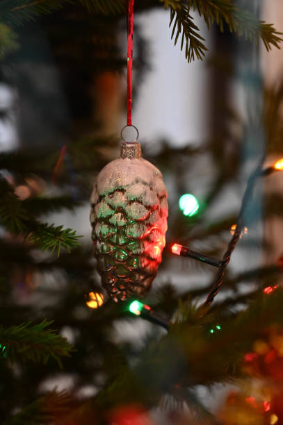 istock Decorative bump toy hanging on decorated Christmas tree. Close-up. 1298461952