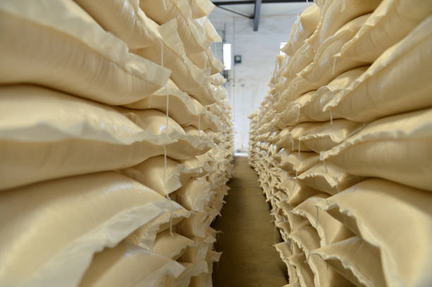 istock Many rows of plastic white sacks with goods are in big warehouse 1298470164
