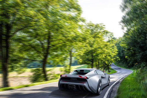 front view of fast moving generic gray sportscar driving on a country road, motion blur,  3D, car of my own design.