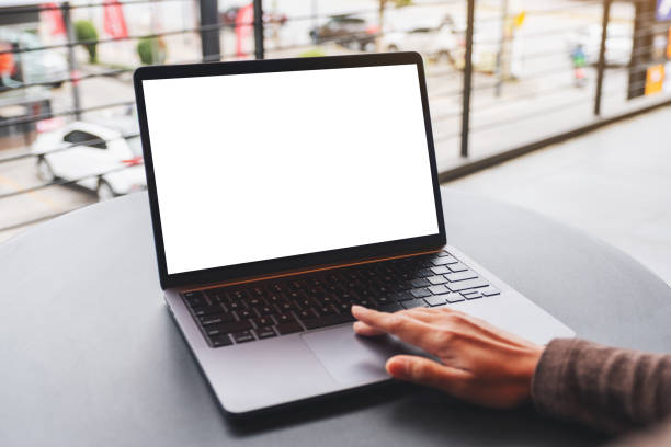 istock a woman using and touching on laptop computer touchpad with blank white desktop screen on the table 1298492122