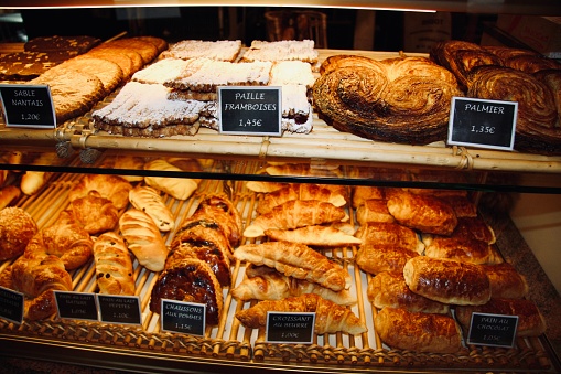 Closeup photo of delicious traditional French pastries in a Patisserie shop window in Paris