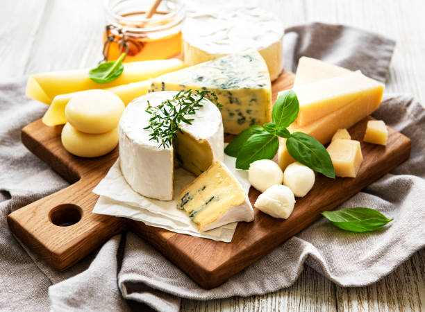 istock Various types of cheese  on a white wooden  background 1298503053