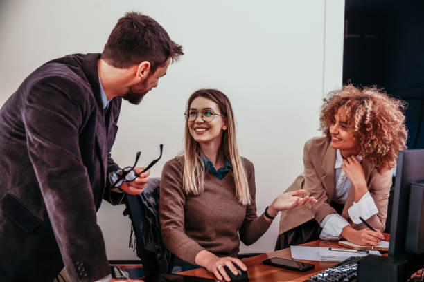 istock Smiling Coworkers chatting 1298503392