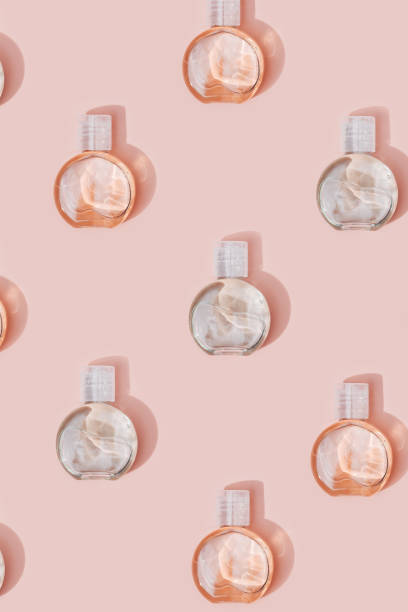 istock Pattern from small cosmetic bottle for cream or gel. Beauty product package, mock up plastic container on pastel pink 1298503528