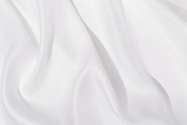 istock Texture of white silk cloth, textile background, drapery and pleats on delicate fabric. 1298503541