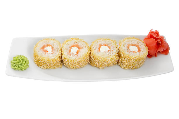 istock Japan baked sushi rolls on a white plate isolated on a white background. Restaurant serving concept. 1298504378