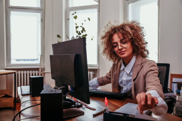 istock Businesswoman reaching for a document 1298504708