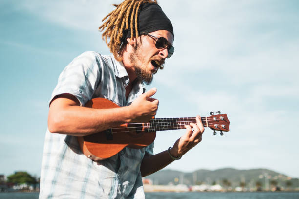 istock a man playing ukulele and singing, in florianopolis 1298508737