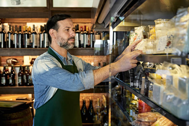 Bearded Gourmet Grocery Store Owner Arranging Merchandise