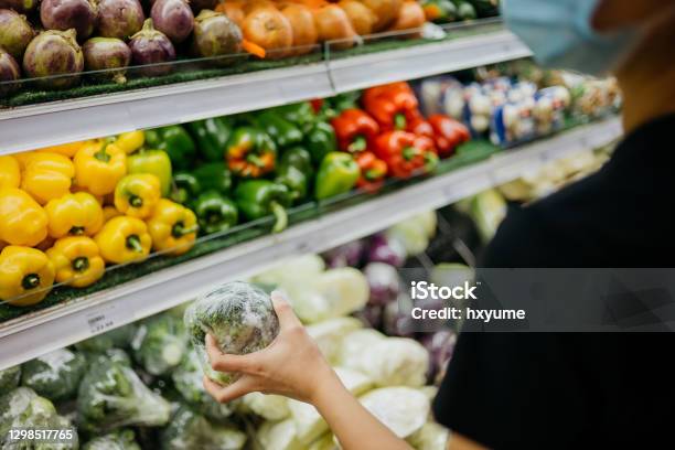Asian Woman With Protective Face Mask Shopping For Fresh Vegetables In Supermarket Stock Photo - Download Image Now