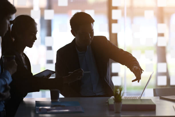 istock Business people using laptop and discuss about the future project plan in modern office. 1298519241