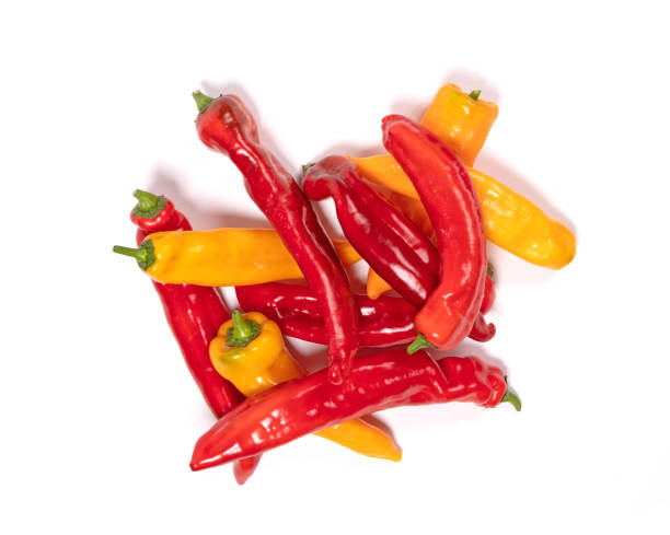 istock Red and yellow sweet pointed peppers, isolated on white background 1298519324