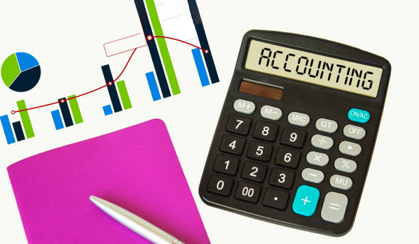 istock Calculator with the text ACCOUNTING on white paper, next to accounting reports and a notebook with a pen 1298520652