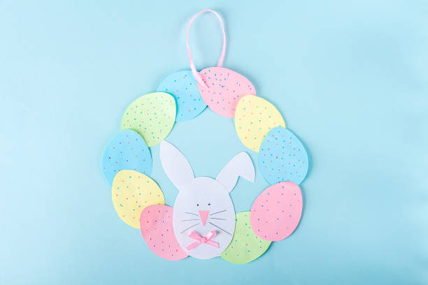 istock DIY and kids creativity. Step by step instruction: how to make paper easter wreath. Step10 insert pink ribbon into finished wreath. Childrens handmade Easter craft. 1298522753