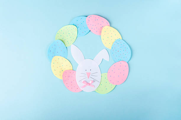 istock DIY and kids creativity. Step by step instruction: how to make paper easter wreath. Step9 glue paper eggs and bunny to circle like wreath. Childrens handmade Easter craft. 1298522756