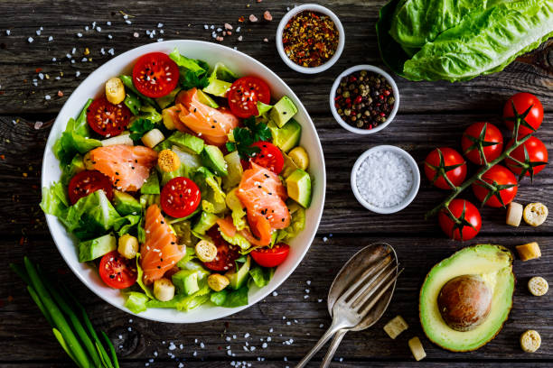 istock Smoked salmon, avocado and vegetables on wooden table 1298525792