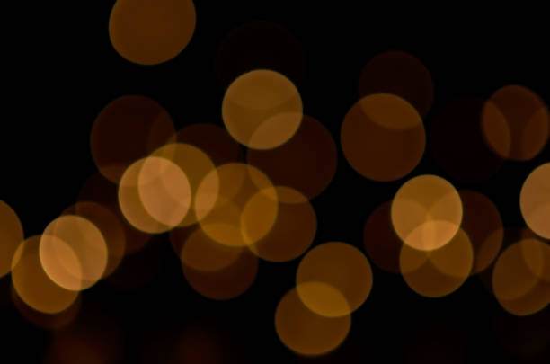 istock blurry yellow round lights on a dark background 1298525851
