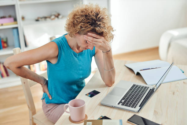 istock Woman working from home and being depressed, tired with headache. Modern concept and problems with freelancers. 1298529377