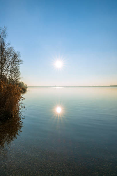 istock Sun shining above a lake 1298529735