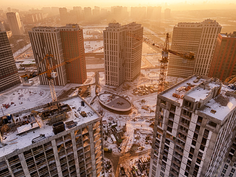 Aerial view on a construction site in the city. Early morning with sun rays.