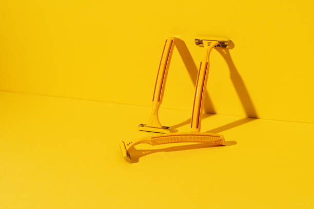 istock Disposable razors on yellow background, studio shot 1298530543