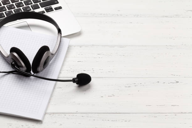 istock Office desk with headset and laptop. Work from home 1298530549
