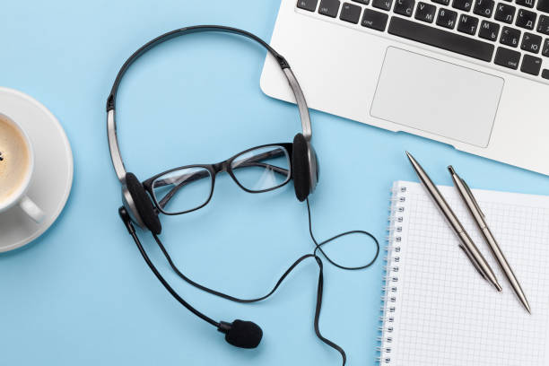 istock Office desk with headset and laptop. Work from home 1298530674