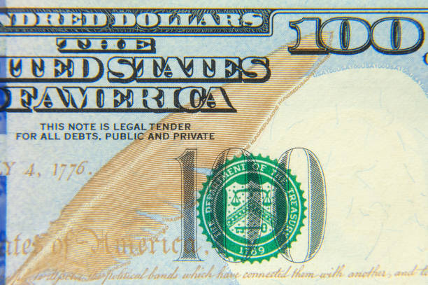 istock 100 dollars banknote closeup macro fragment. 1298531623