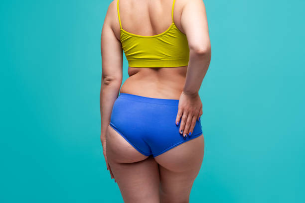 fat hips and buttocks, obesity female body on blue background - sex symbol sensuality women overweight imagens e fotografias de stock