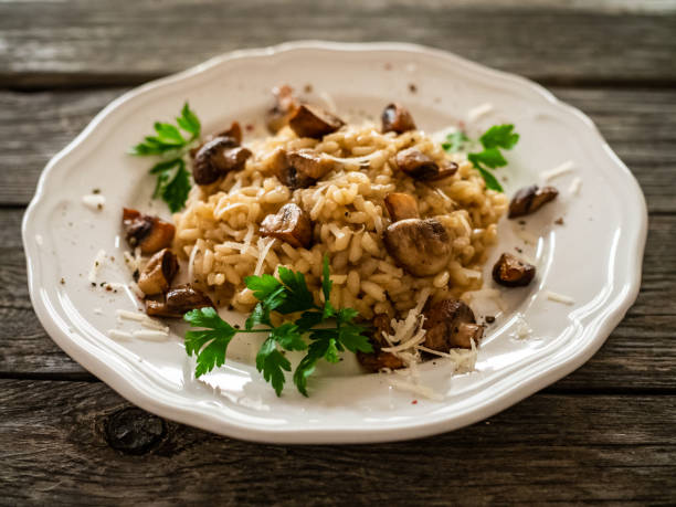 istock Risotto with champignon and parmesan on wooden table 1298535461